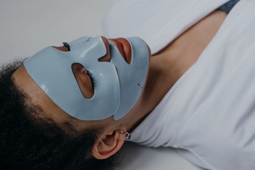 Close-up of a woman wearing a clay face mask, promoting self-care and relaxation.